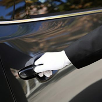 Driver opening a car door - Chauffeur Services in Hampshire